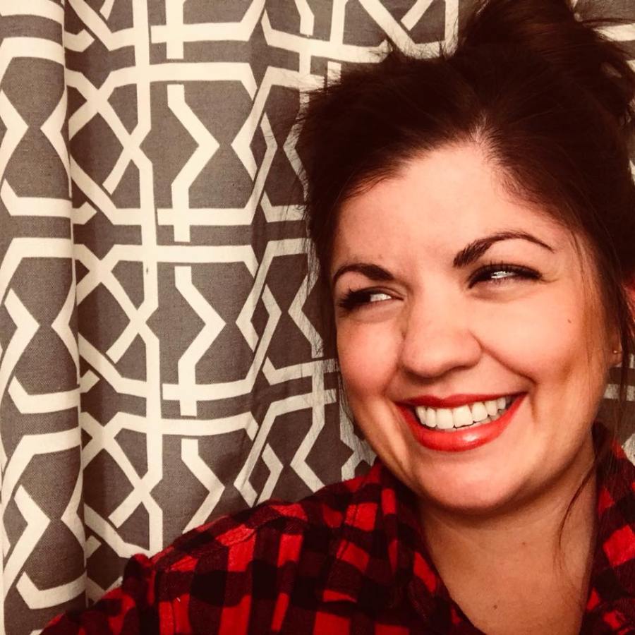 Rosey Profile Picture - smiling, looking to the side against a grey and white patterned background